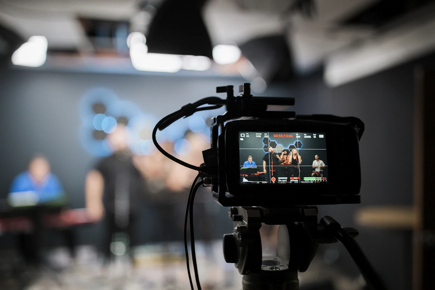 Video camera recording a band performing in a studio
