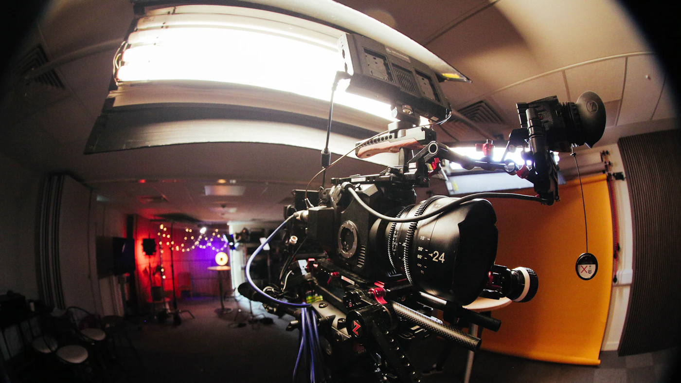 Professional cinema camera set up in a studio hallway with lights